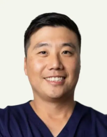 Dr. Park, dentist at Silver Spring dental practice, smiling in professional portrait.